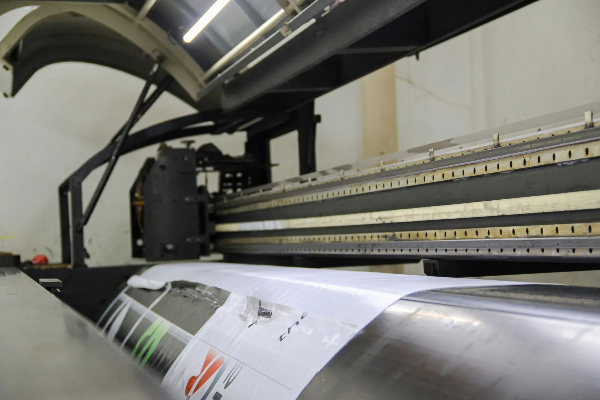 Printing press printing a large sheet of paper